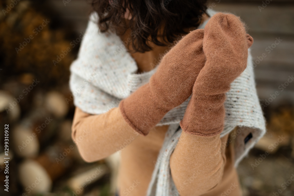 Warmly dressed woman enjoying winter near a rustic woodshed while practicing mindfulness and wellness Warmly dressed woman enjoying winter near a rustic woodshed while practicing mindfulness and wellness