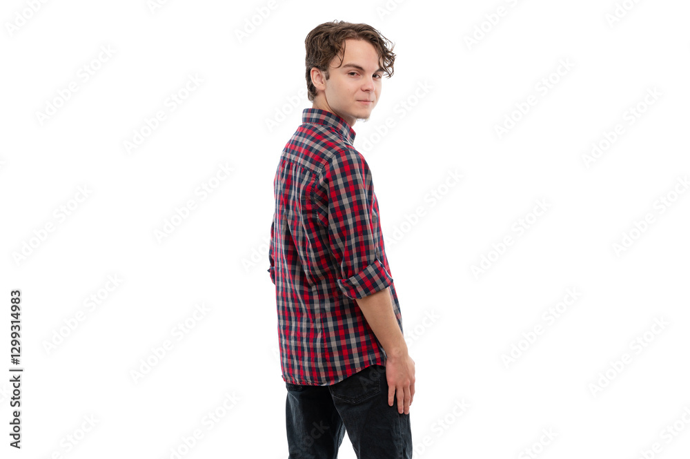 A young man in a checkered shirt looking back over his shoulder against a white background. A young man in a checkered shirt looking back over his shoulder against a white background.