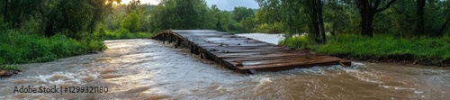 Wallpaper Mural A damaged wooden bridge being overwhelmed by fast-moving water after a major flood. Generative AI Torontodigital.ca