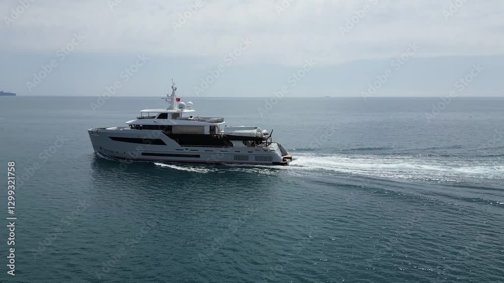 Luxury yacht cruising the open sea with stunning views and sunny skies Luxury yacht cruising the open sea with stunning views and sunny skies