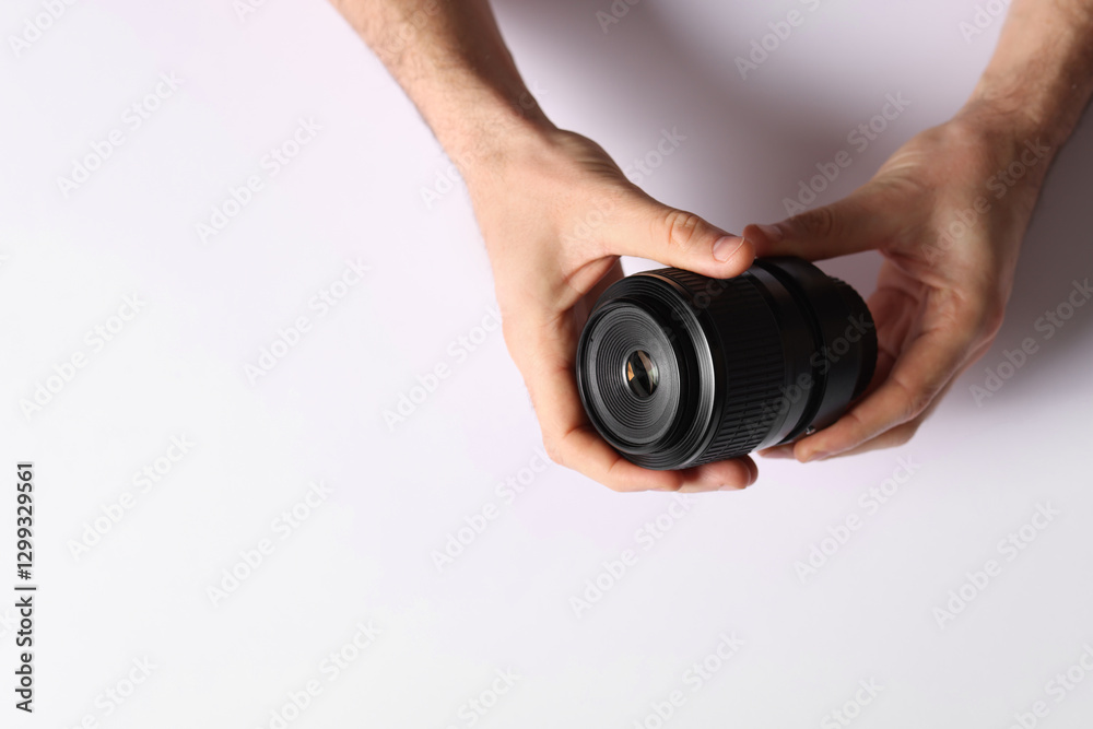 Photographer with camera lens on light background, top view. Space for text Photographer with camera lens on light background, top view. Space for text