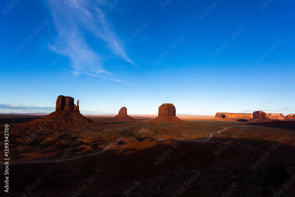 Afternoon light on sandstone buttes in the desert of Monument Valley, in Arizona and Utah. Afternoon light on sandstone buttes in the desert of Monument Valley, in Arizona and Utah.