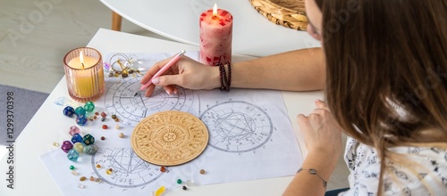 Woman astrologer draws a natal chart. Selective focus