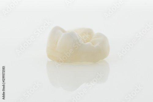 High-quality zirconia dental crown on white background. Dental ceramic crown professional dental lab