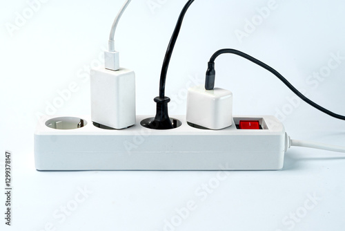 A close-up of a white power strip with multiple plugs connected, showcasing a clean and organized setup against a light background, ideal for home or office use.