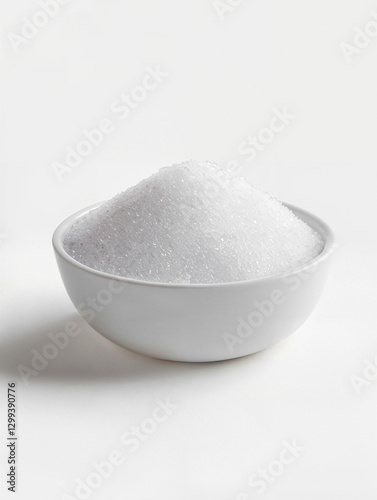 White crystalline substance in bowl on light background showcasing culinary ingredient for cooking and baking tasks