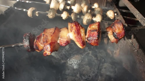 Roast meat and mushrooms over an open fire. Cooking outdoors.