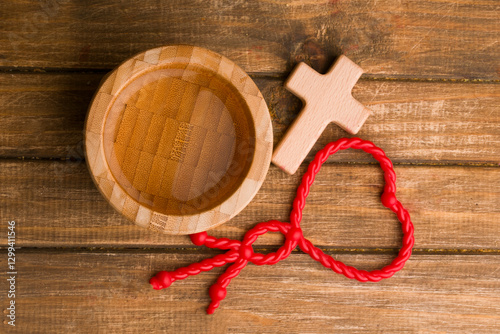 bowl with holy water and wooden cross