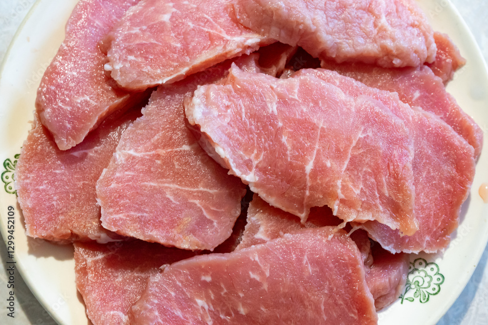 Freshly sliced pork ready for cooking in a home kitchen Freshly sliced pork ready for cooking in a home kitchen