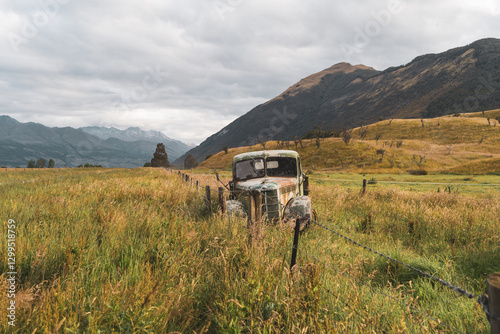 Old and rusty abandoned car on a field
