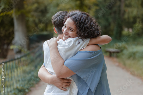 Hug from a happy mother to her teenage son. Tenderness, love, family.