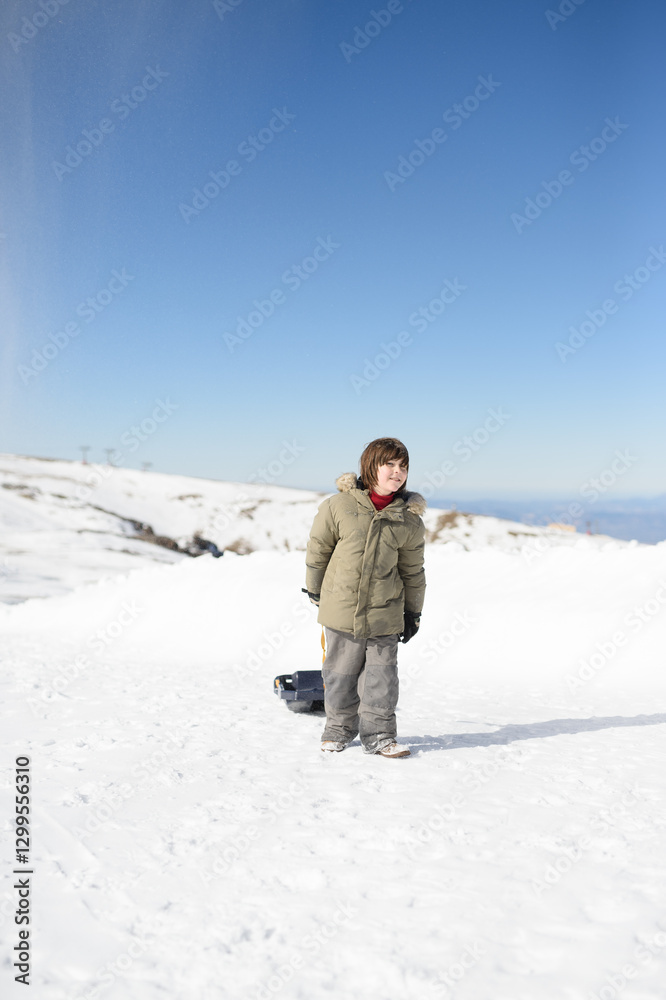 Child Playing in Snow at Sierra Nevada Ski Resort in Winter