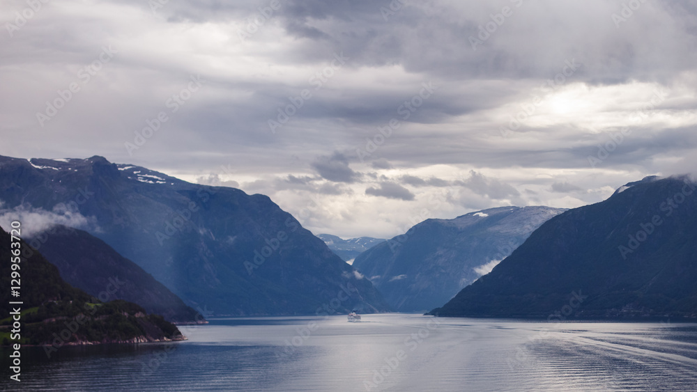 Breathtaking Norwegian Fjord with Majestic Mountains and Overcast Sky Reflected in Calm Water - A Scenic View of Nature's Beauty and Wonder Awaiting Exploration and Adventure Breathtaking Norwegian Fjord with Majestic Mountains and Overcast Sky Reflected in Calm Water - A Scenic View of Nature's Beauty and Wonder Awaiting Exploration and Adventure