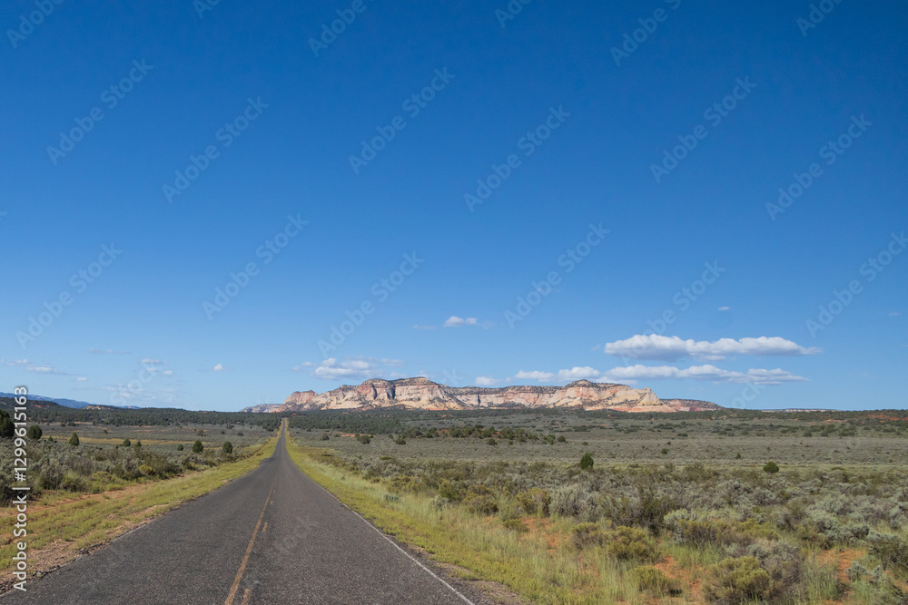 Long straight road thru Utah with mountains background Long straight road thru Utah with mountains background