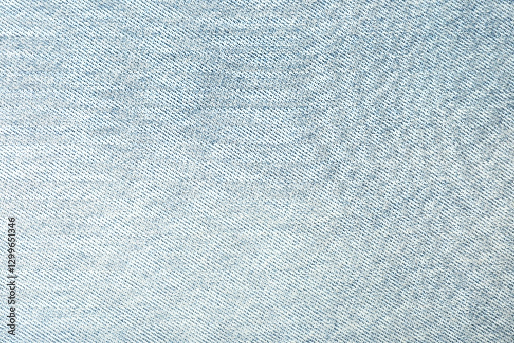 Fototapeta premium Texture of light blue jeans as background, closeup