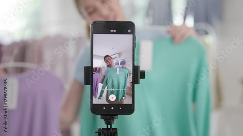 Gen Z vlogger SME owner go green net zero thrift store sale live stream talk on mobile social media online second hand sell. Asia people young woman record home video camera app eco shop side hustle.