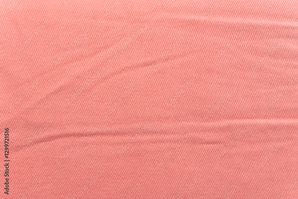Fototapeta premium Background texture of orange pink woven fabric for wear made of soft cotton. Spring and summer season
