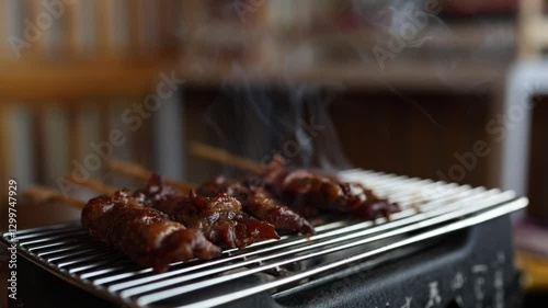cooking outdoor as we camp on a mountain surrounded by abundant nature, family members are helping to cook both barbecue and grilled food, including meat and vegetables, close-up