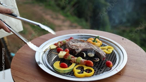 cooking outdoor as we camp on a mountain surrounded by abundant nature, family members are helping to cook both barbecue and grilled food, including meat and vegetables, close-up