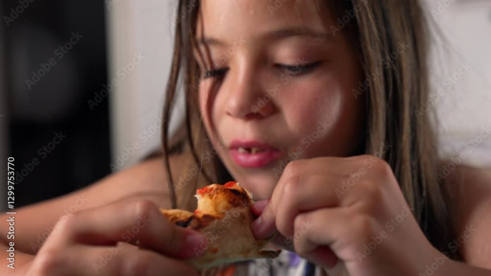 Young girl biting into a piece of pizza crust, holding it with both hands, eyes closed in a moment of enjoyment, seated indoors at a table, with a close-up focus on her facial expression Young girl biting into a piece of pizza crust, holding it with both hands, eyes closed in a moment of enjoyment, seated indoors at a table, with a close-up focus on her facial expression