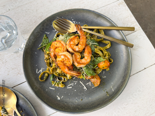 shrimp and pasta served on a plate