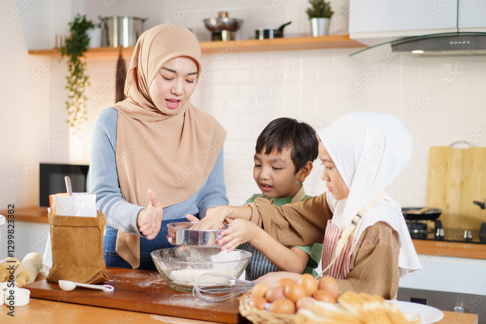Asian muslim woman and lovely children are preparing and cooking in the kitchen. Asian muslim woman and lovely children are preparing and cooking in the kitchen.