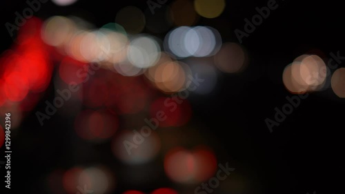 Night road lights blurred bokeh of cars in traffic on the road at night. Abstract bright blurred colored bokeh. Bokeh lights in the city night background