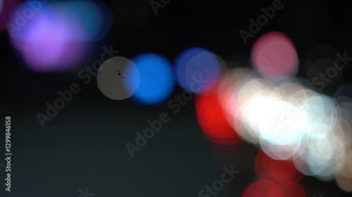 Night road lights blurred bokeh of cars in traffic on the road at night. Abstract bright blurred colored bokeh. Bokeh lights in the city night background