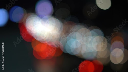 Night road lights blurred bokeh of cars in traffic on the road at night. Abstract bright blurred colored bokeh. Bokeh lights in the city night background