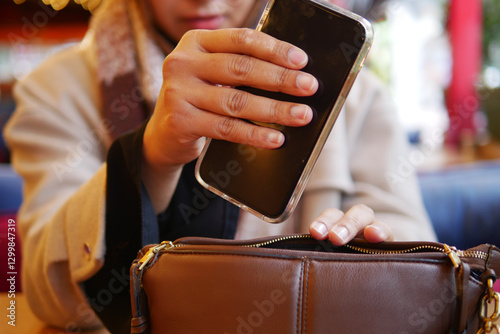 Wallpaper Mural  women taking smart phone our from her casual purse  Torontodigital.ca