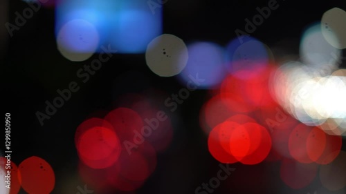 Night road lights blurred bokeh of cars in traffic on the road at night. Abstract bright blurred colored bokeh. Bokeh lights in the city night background