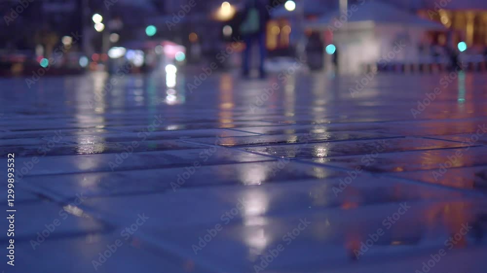 Evening reflections on wet pavement in a vibrant city setting Evening reflections on wet pavement in a vibrant city setting