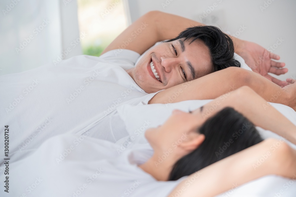Couple enjoying a peaceful morning together in bed with soft natural light Couple enjoying a peaceful morning together in bed with soft natural light