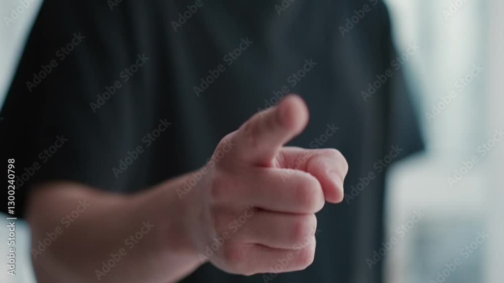 Close-up of a finger pointing as a gesture of warning or instruction