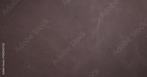 the hot surface of a frying pan heated for cooking on which there is smoke, smoke from a hot black frying pan during its incandescence for cooking pancakes