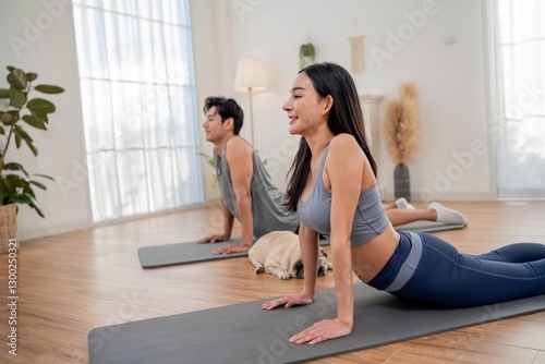 Wallpaper Mural Couple practicing yoga in a serene indoor space while a dog rests nearby Torontodigital.ca