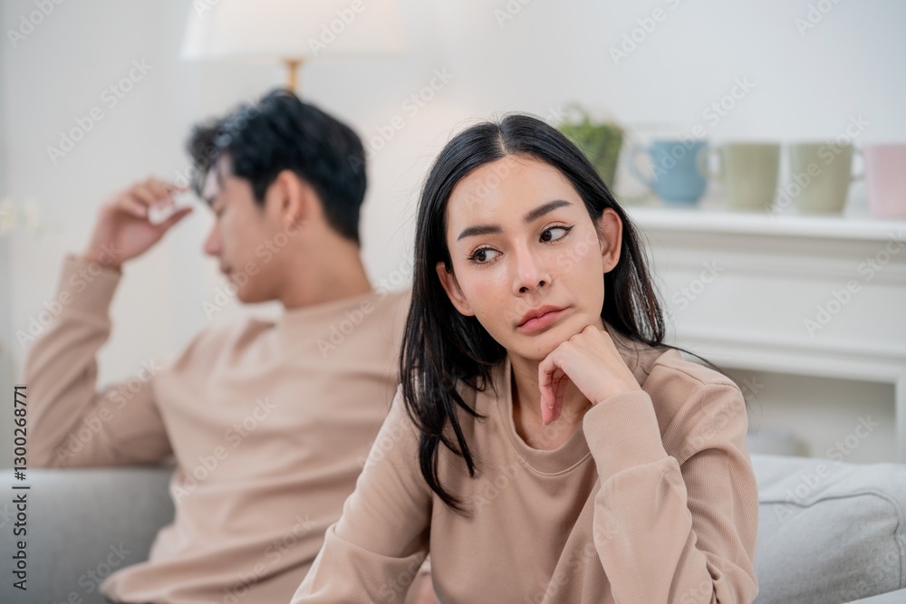Couple facing relationship tension in a cozy living room during a quiet afternoon Couple facing relationship tension in a cozy living room during a quiet afternoon