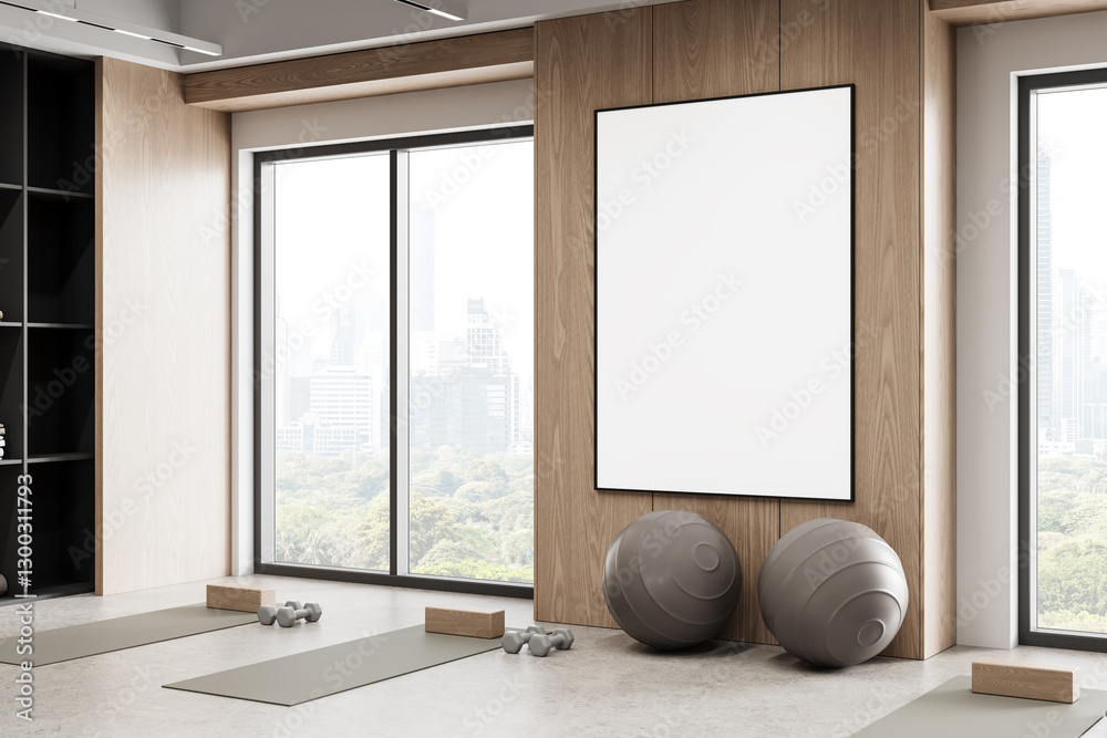 Fototapeta premium Blank framed poster mockup in modern gym interior with yoga mats, exercise balls, and city view through large windows. 3D Rendering