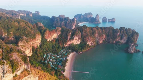 Drone sunset view of Krabi most famous beach Railay on the Andaman sea in Ao nang beach aerial footage of Thailand holiday destination with resort and cliff