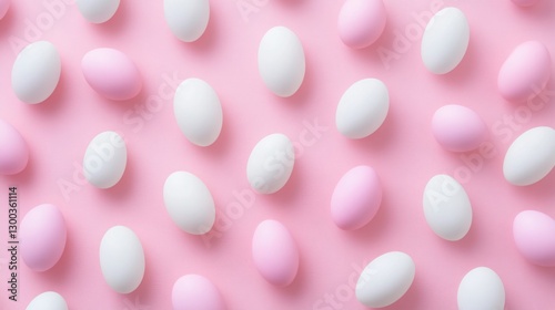 Flat lay of an Easter egg pattern on a pastel pink background, featuring a modern minimalist design with space for text. Includes Easter candy and chocolate eggs, perfect for festive promotions photo