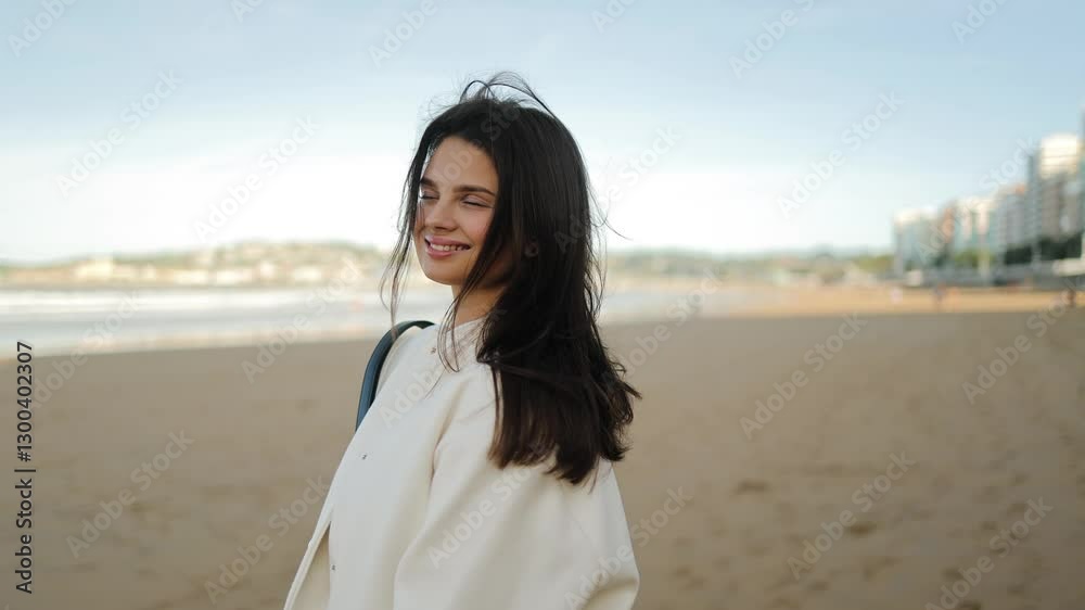 Portrait of smiling woman posing on the beach, touching her hair in the wind, spring, freshness, sand and beach, sensuality and tenderness, freedom, fresh air, youth, pleasure, tranquility, face Portrait of smiling woman posing on the beach, touching her hair in the wind, spring, freshness, sand and beach, sensuality and tenderness, freedom, fresh air, youth, pleasure, tranquility, face