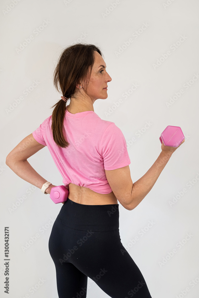 Fitness woman doing exercise workout with dumbbells isolated on white Fitness woman doing exercise workout with dumbbells isolated on white