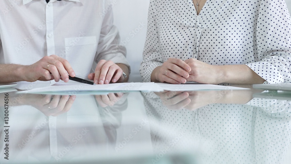 Business colleagues reviewing a contract, engaging in negotiations and strategic decision making in a professional office setting, white casual dress style. Business people concept