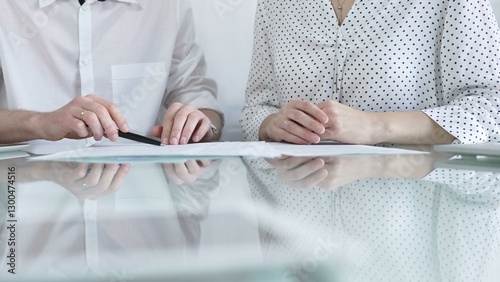 Obraz na płótnie Business colleagues reviewing a contract, engaging in negotiations and strategic decision making in a professional office setting, white casual dress style. Business people concept w salonie