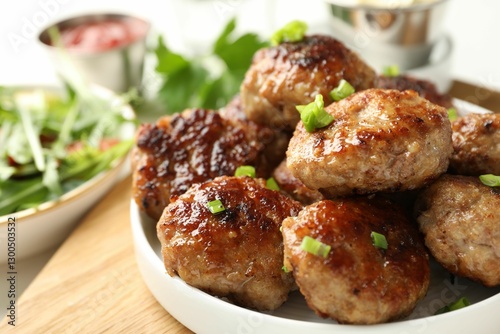 Obraz na płótnie Delicious patties with green onions on table, closeup