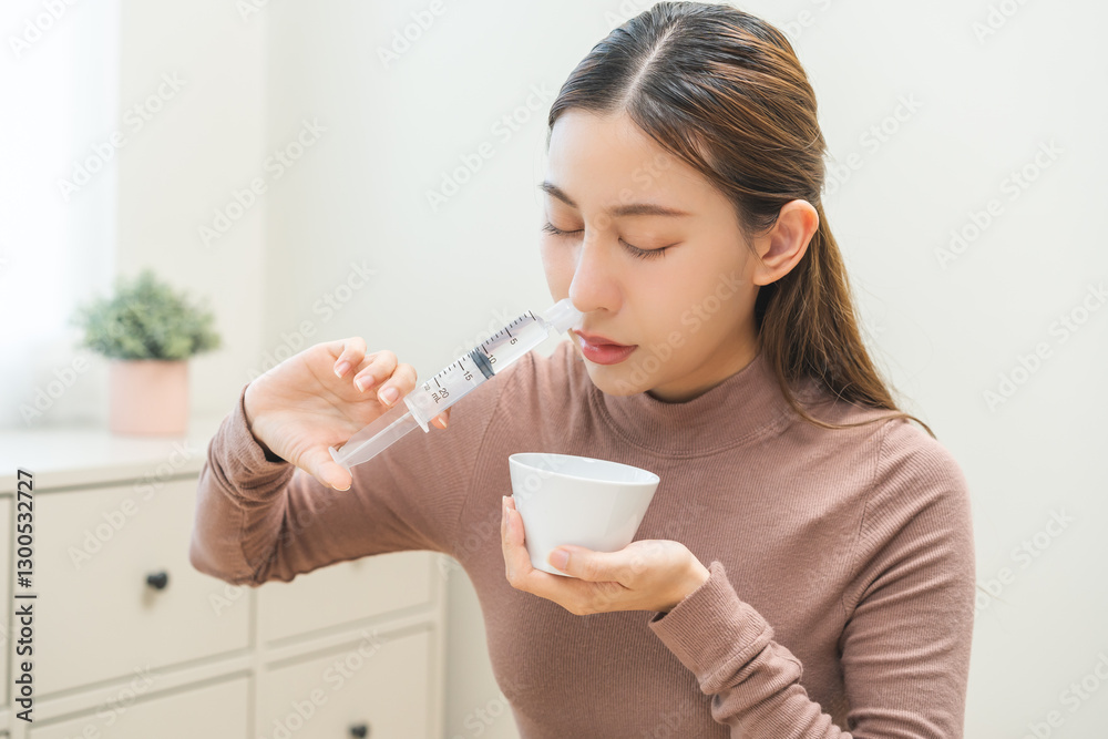 Health care wash nose, cleaning nose concept. Nasal irrigation asian young woman illness have a flu, fever, have a runny nose. Girl washes out nose with syringe and saline, infection, dust allergic. Health care wash nose, cleaning nose concept. Nasal irrigation asian young woman illness have a flu, fever, have a runny nose. Girl washes out nose with syringe and saline, infection, dust allergic.