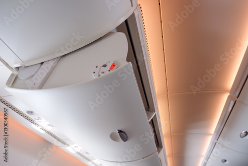 Open overhead compartment baggage storage inside economy airplane cabin