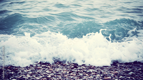 A top view of turquoise waves rolling onto a serene summer beach, with soft light casting a peaceful glow over the calm seascape and inviting relaxation.