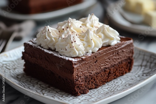 Decadent chocolate brownie with whipped cream on a plate photo