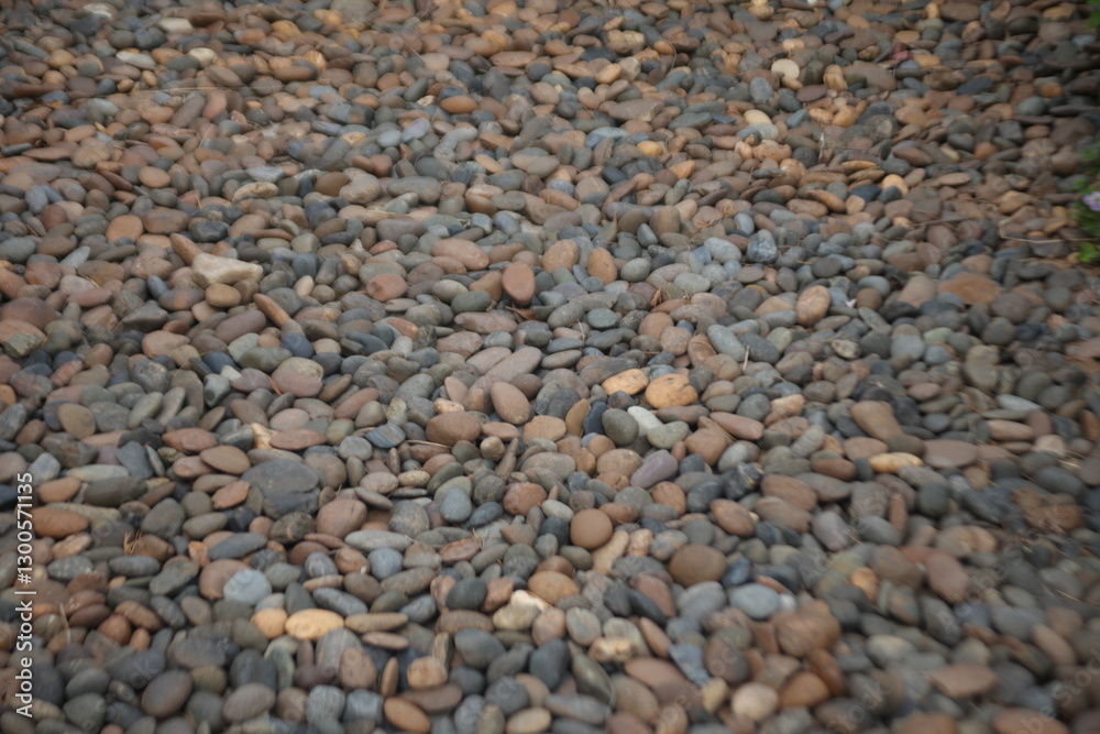 Pebbles texture:A close-up shot of a surface covered in smooth, water-worn pebbles, revealing a rich tapestry of textures and earth tones.
